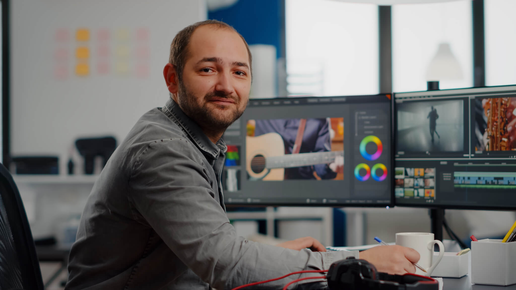 videographer-smiling-at-camera-working-on-computer.jpg